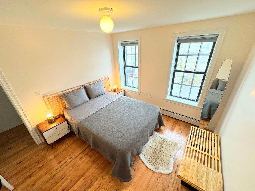 a bedroom with a bed and two windows at The Waltham Private Room & Bathroom JFK LGA 10min I 20min ManhattanPenn Station bullet-train in Queens