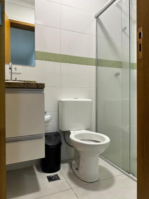 a bathroom with a toilet and a glass shower at Hotel Aeroporto Congonhas 5 in Sao Paulo