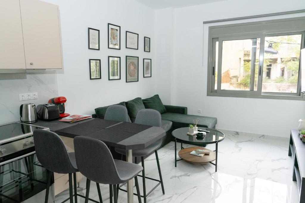 a living room with a table and a green couch at Ermis apartment in Athens