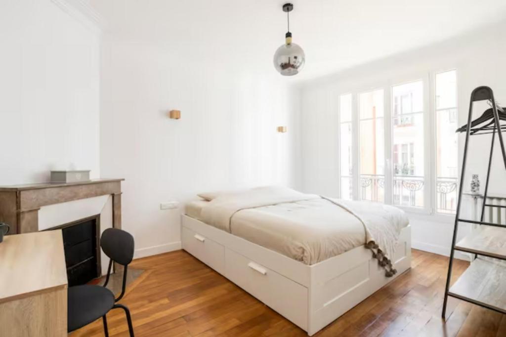 a white bedroom with a bed and a fireplace at The Square, Paris-Asnières, Private Apartment with Bedroom and Living Room in Asnières-sur-Seine