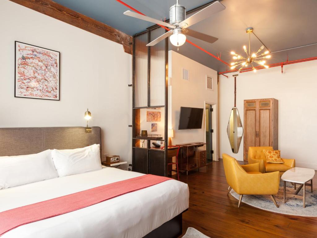 a hotel room with a bed and a chair at The Old No. 77 Hotel & Chandlery in New Orleans