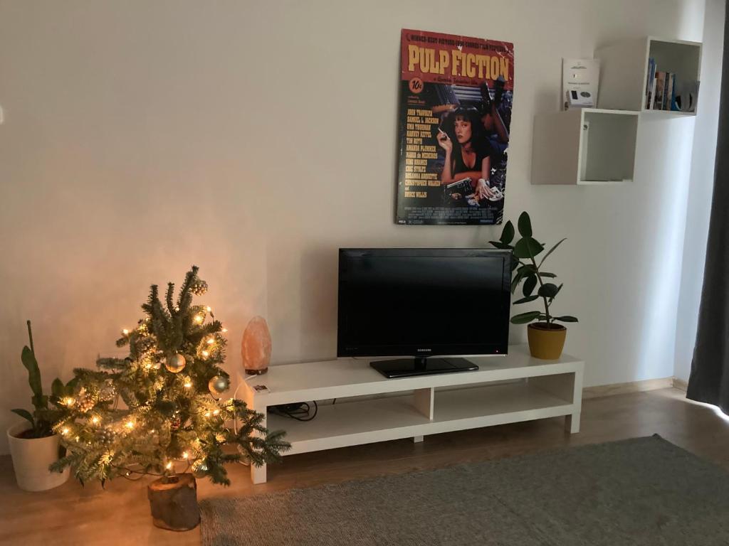 a living room with a television and a christmas tree at Apartment next to the river in Budapest