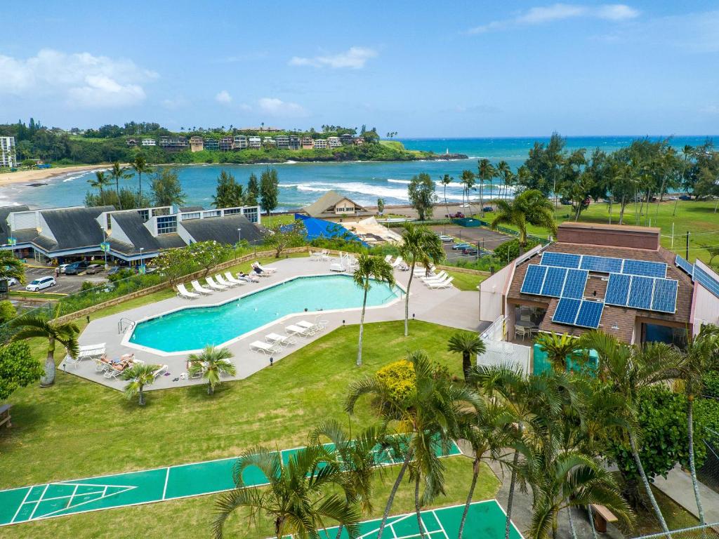 an aerial view of a resort with a swimming pool and the ocean at Kauai Banyan Harbor B24 condo in Lihue