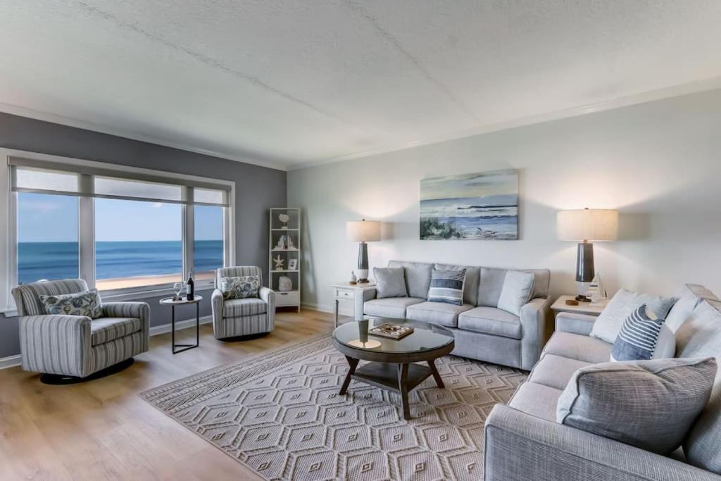 a living room with a couch and a table at Oceanfront Elegance at AIP Resort in Amelia Island