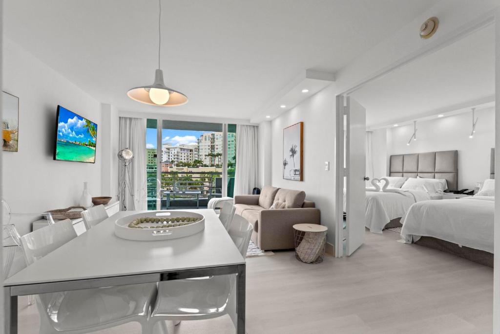 a hotel room with two beds and a living room at Luxury Condo Hotel with full kitchen, located at 5 mints walk to the beach in Fort Lauderdale