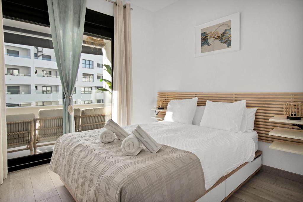Tempat tidur dalam kamar di Apartamento nordico boho con piscina en Estepona - ESTEPONA GARDEN 5 1B