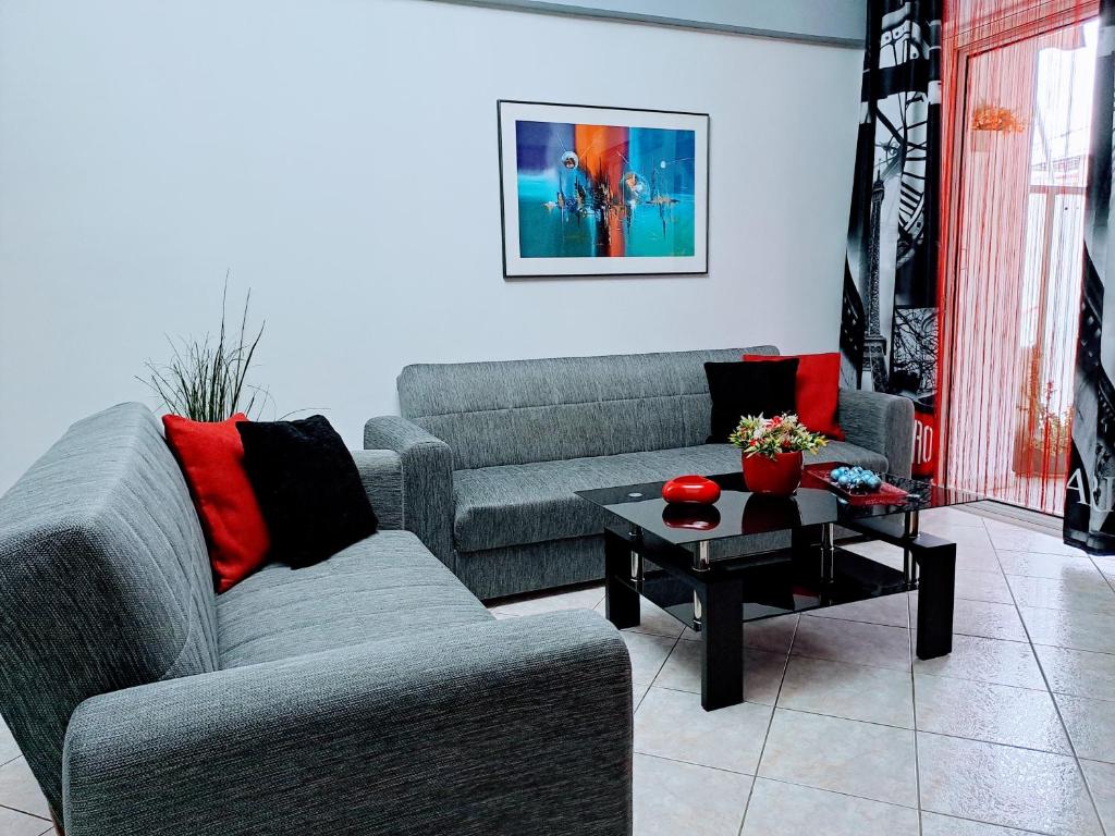 a living room with two couches and a coffee table at Bright apartment in Nea Palatia • Oropos in Néa Palátia