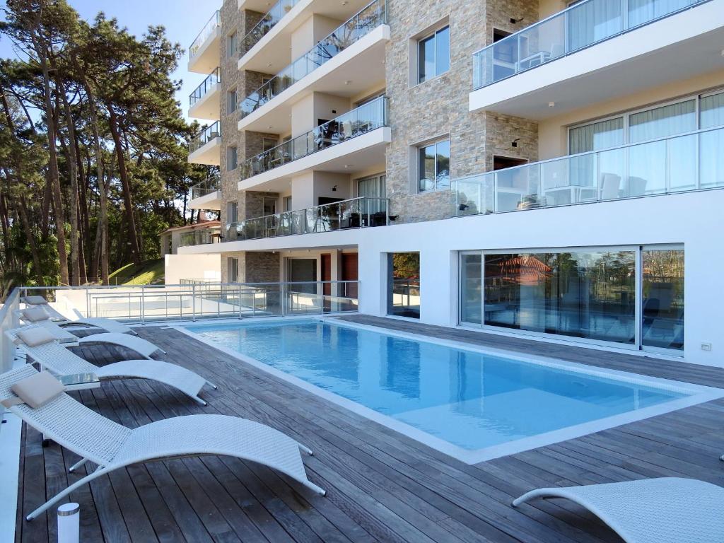 an image of a swimming pool on the deck of a building at Emerald Apartments - Parrillero exclusivo in Punta del Este