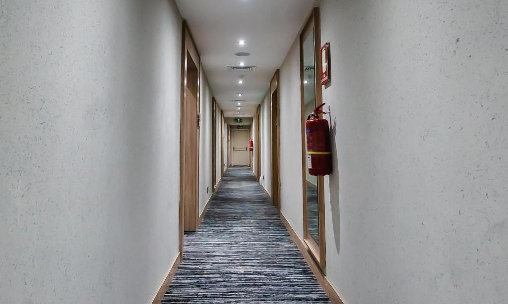 a long hallway with a fire extinguisher on the wall at Sunflower Residence Victoria Island in Lagos