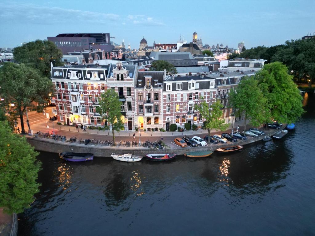 an aerial view of a large building next to a river at Boutique Hotel View in Amsterdam