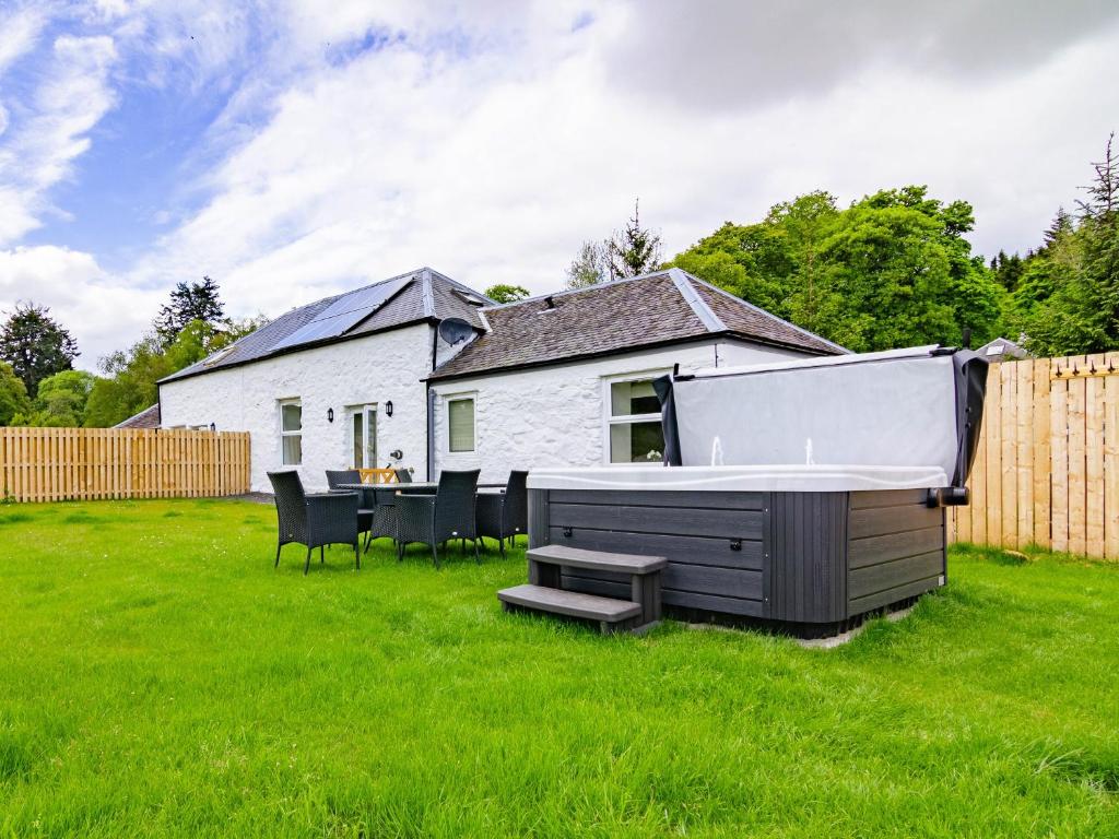 a backyard with a hot tub and a table and chairs at Easter Caiplich - Uk30263 in Cray