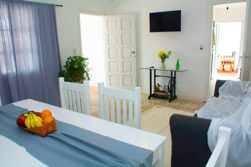 a living room with a table with fruit on it at Casa Aconchego in Paso de los Libres