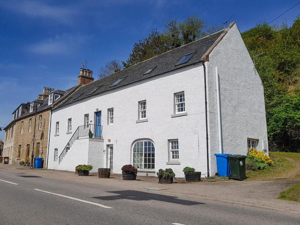 a white building on the side of a street at The Old Chandlery in Avoch