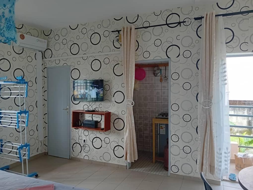 a kitchen with a wall with a bunch of circles on it at Partners Residence in Douala