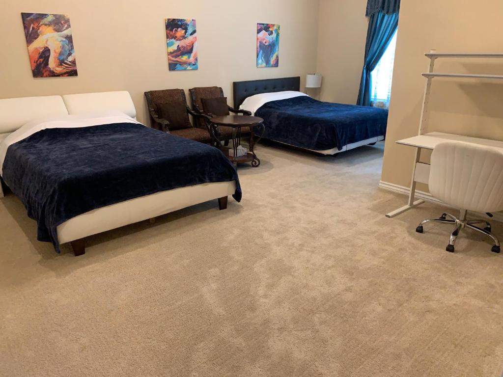 a room with two beds and a table and chairs at AirBB Rooms in Mansion in Riverside