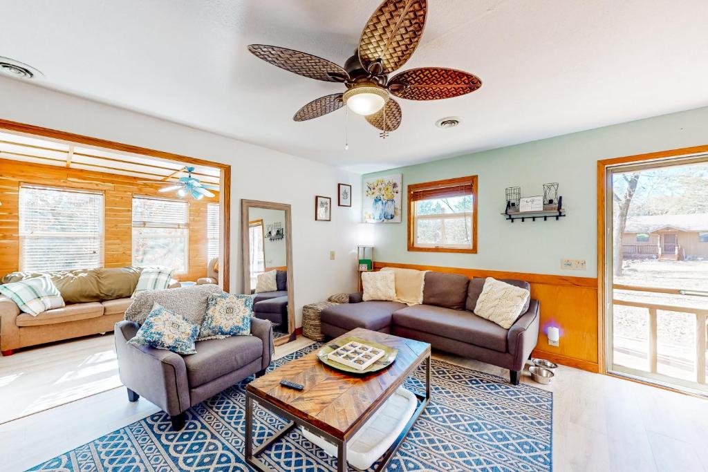 a living room with two couches and a ceiling fan at The Cove in Golden