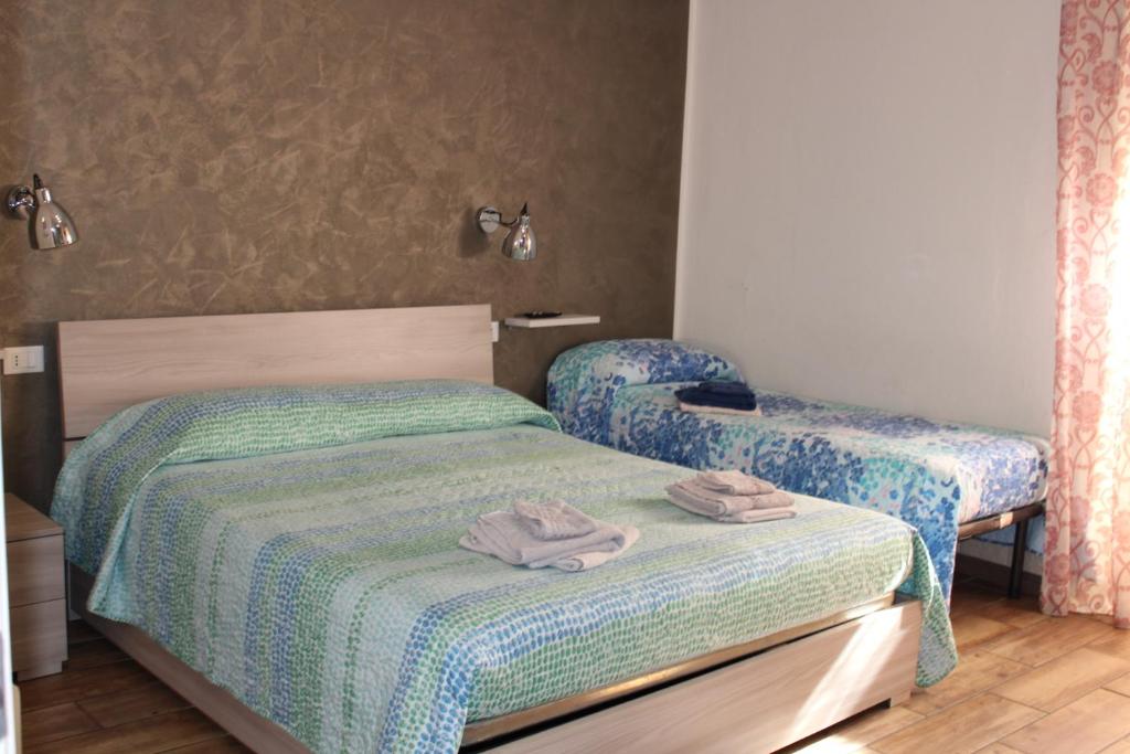 A bed or beds in a room at Alghero Budget