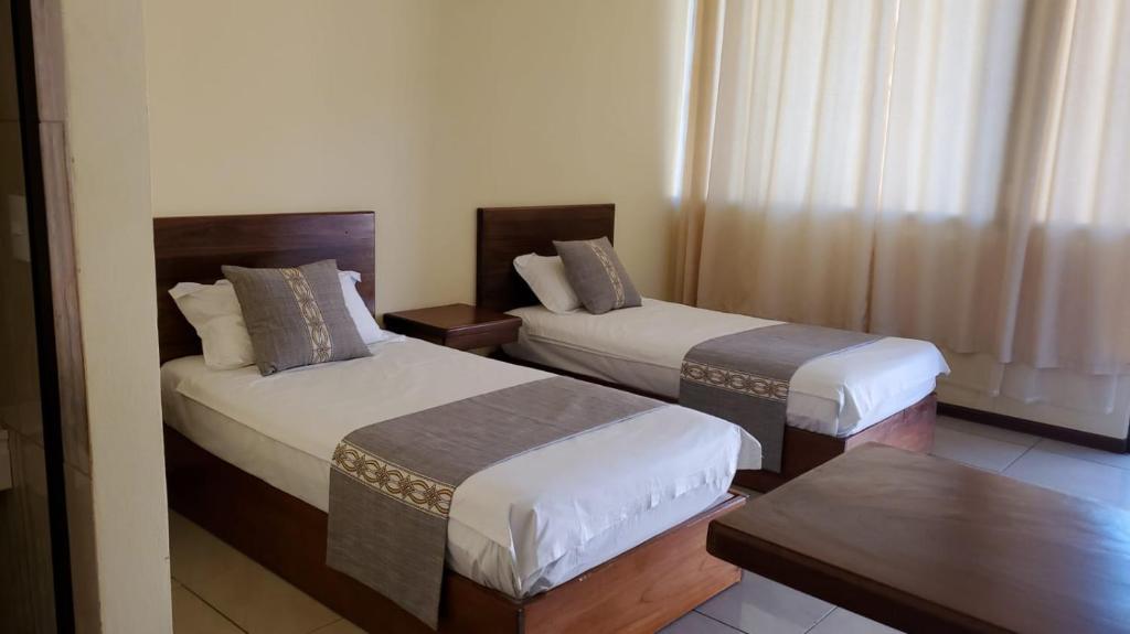 Postel nebo postele na pokoji v ubytování Villa Garita Inn