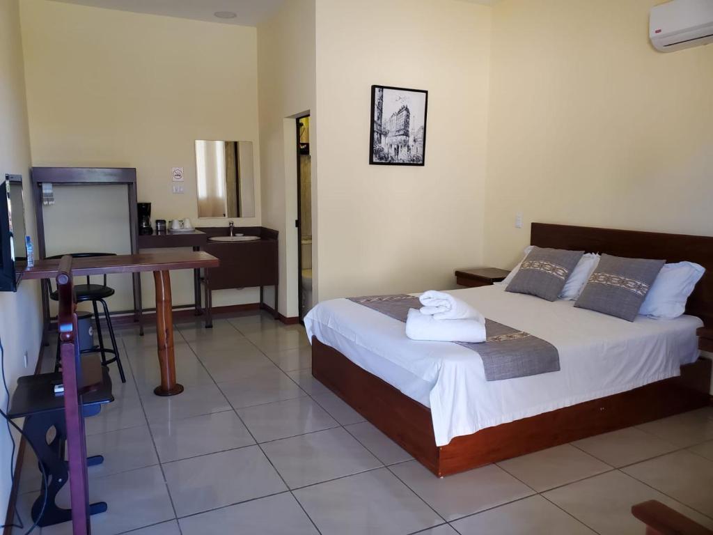 Postel nebo postele na pokoji v ubytování Villa Garita Inn