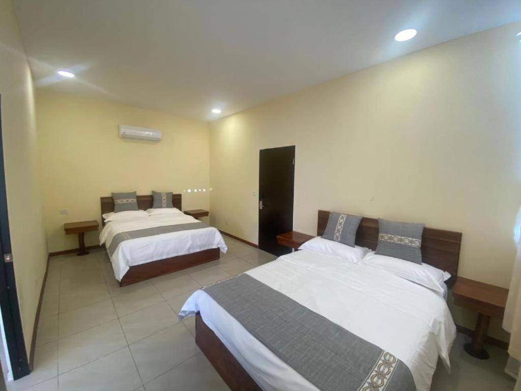 Postel nebo postele na pokoji v ubytování Villa Garita Inn