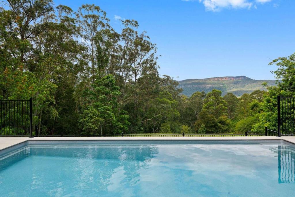 a swimming pool with a view of the mountains at Paddington, Kangaroo Valley in Barrengarry