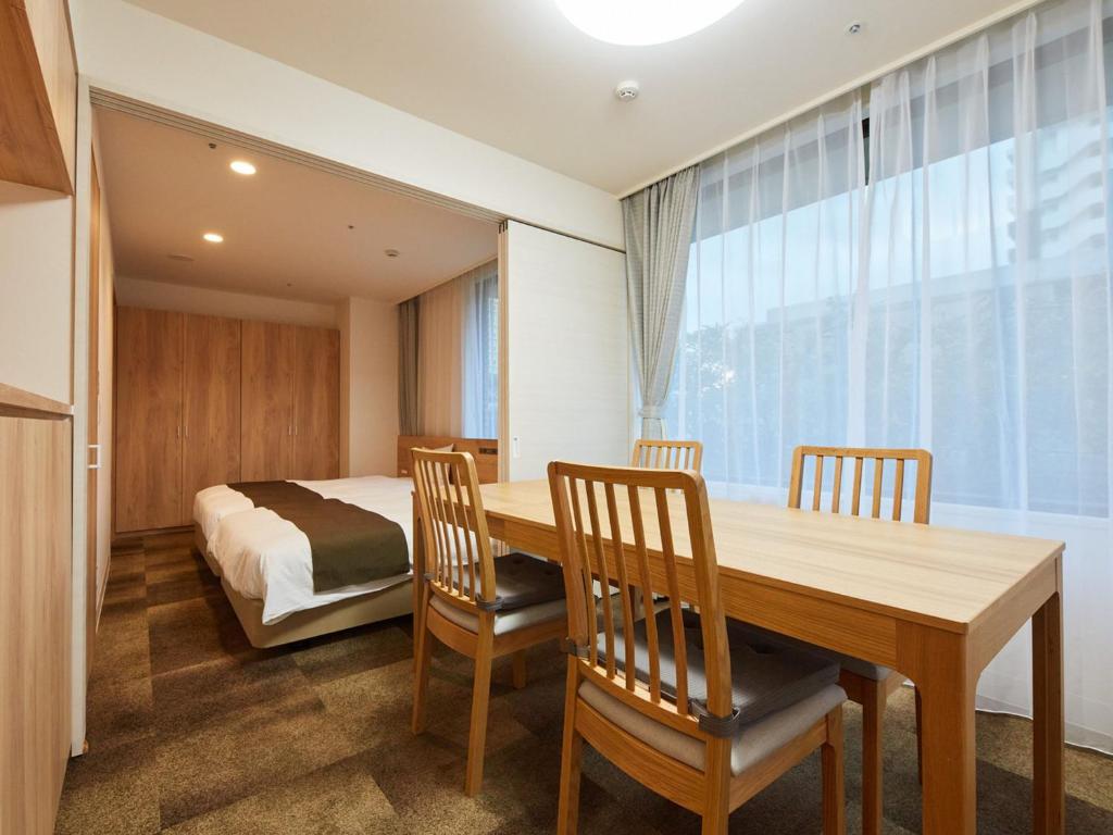Postel nebo postele na pokoji v ubytování Rembrandt Hotel Atsugi