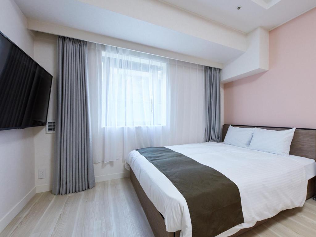 Postel nebo postele na pokoji v ubytování Rembrandt Hotel Atsugi