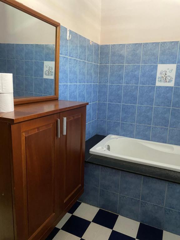 a bathroom with a tub and a sink and a mirror at Homestay 484 in Pleiku