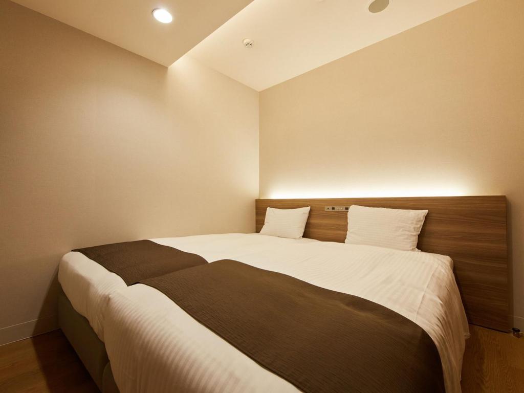 Postel nebo postele na pokoji v ubytování Rembrandt Hotel Atsugi