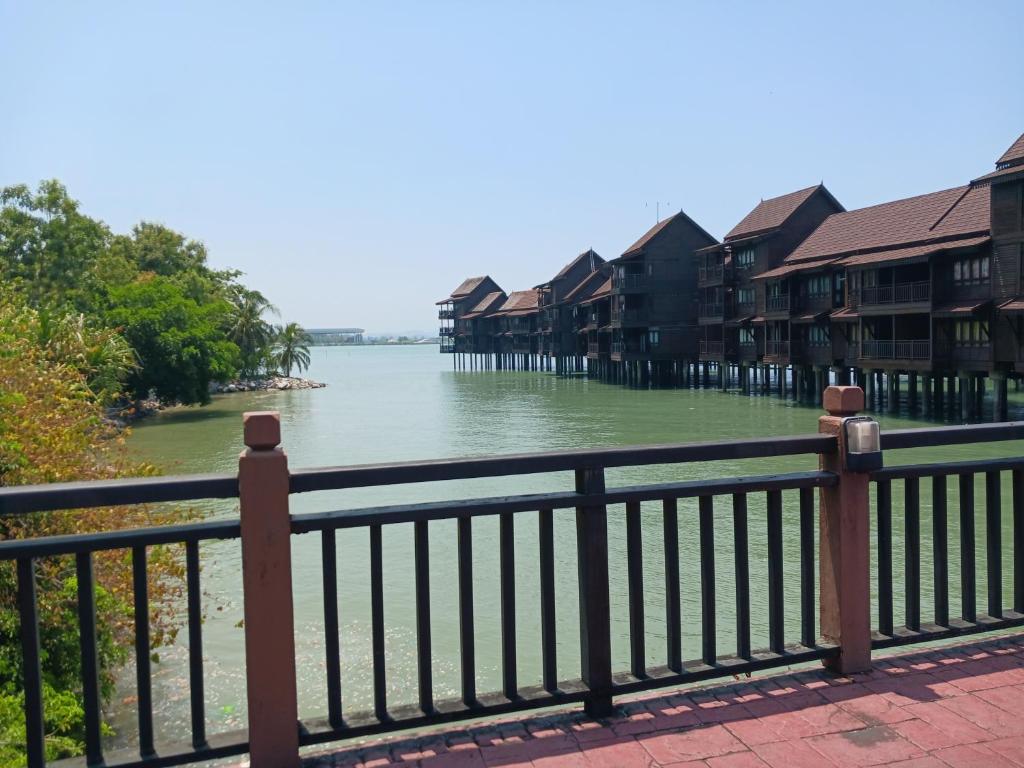 a view of a river with houses and a fence at Villa Dalam Laut 538 in Pantai Cenang