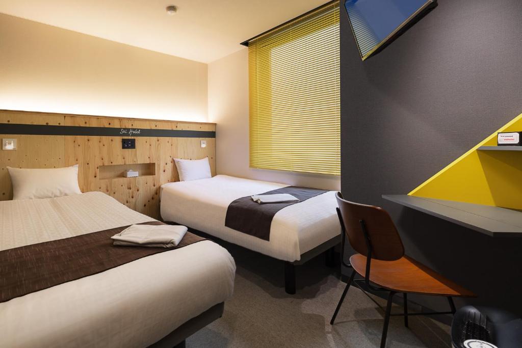 Tempat tidur dalam kamar di Sai Hotel
