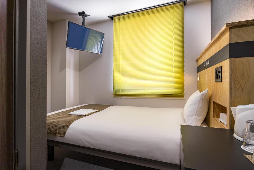 Postel nebo postele na pokoji v ubytování Sai Hotel