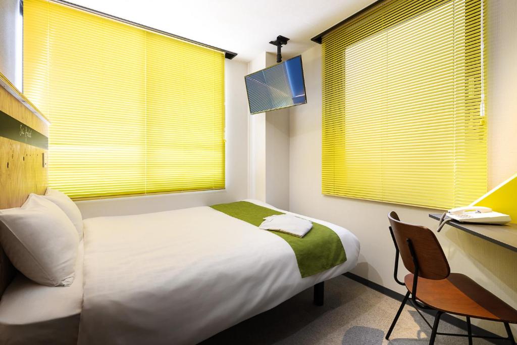 Postel nebo postele na pokoji v ubytování Sai Hotel