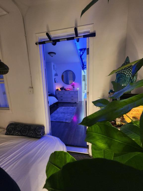 a bedroom with a bed and a plant in a room at Zen Oasis in Newark