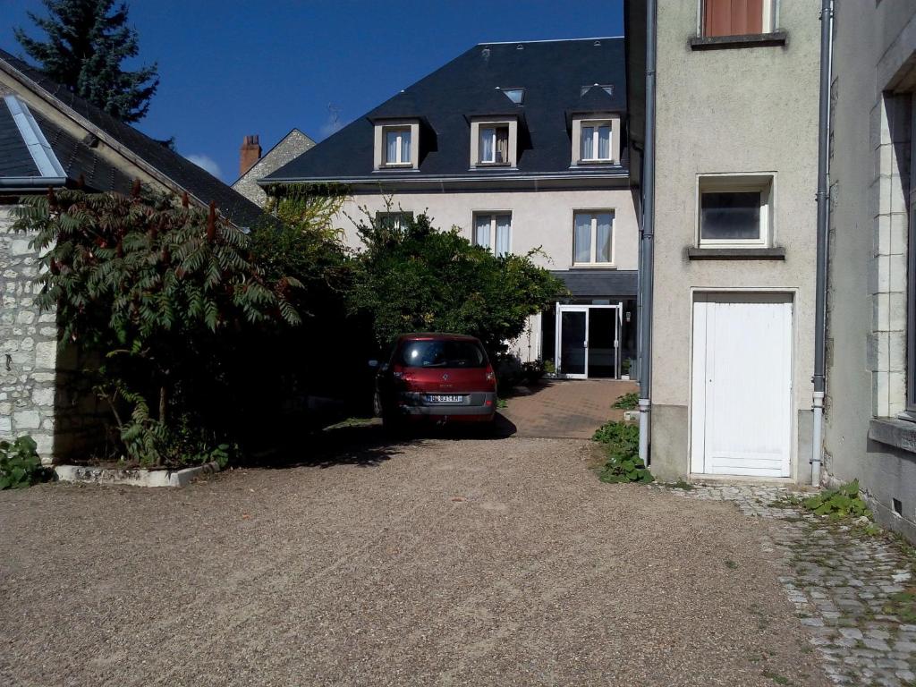 a car parked in the driveway of a house at Jackotel in Orléans