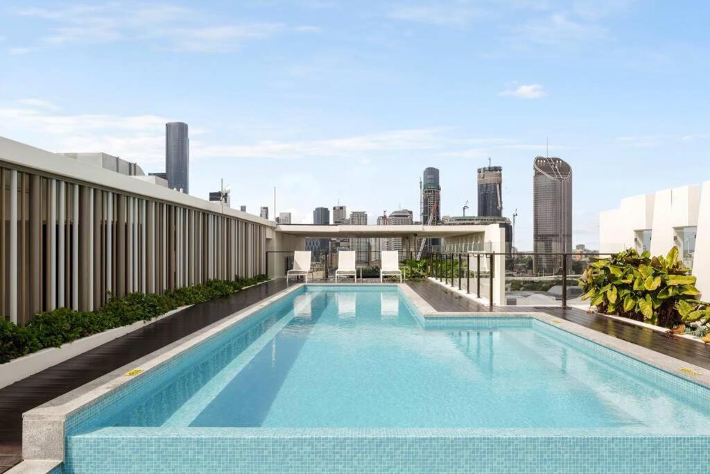 a swimming pool on the roof of a building at CASSA OPERA - Spacious 3B Apartment in the Heart Managed by The Cassa in Brisbane