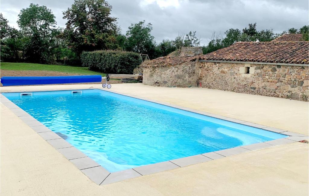 - une piscine en face d'une maison dans l'établissement Awesome Home In Argenton Leglise With Private Swimming Pool, Can Be Inside Or Outside, à Argenton lʼÉglise