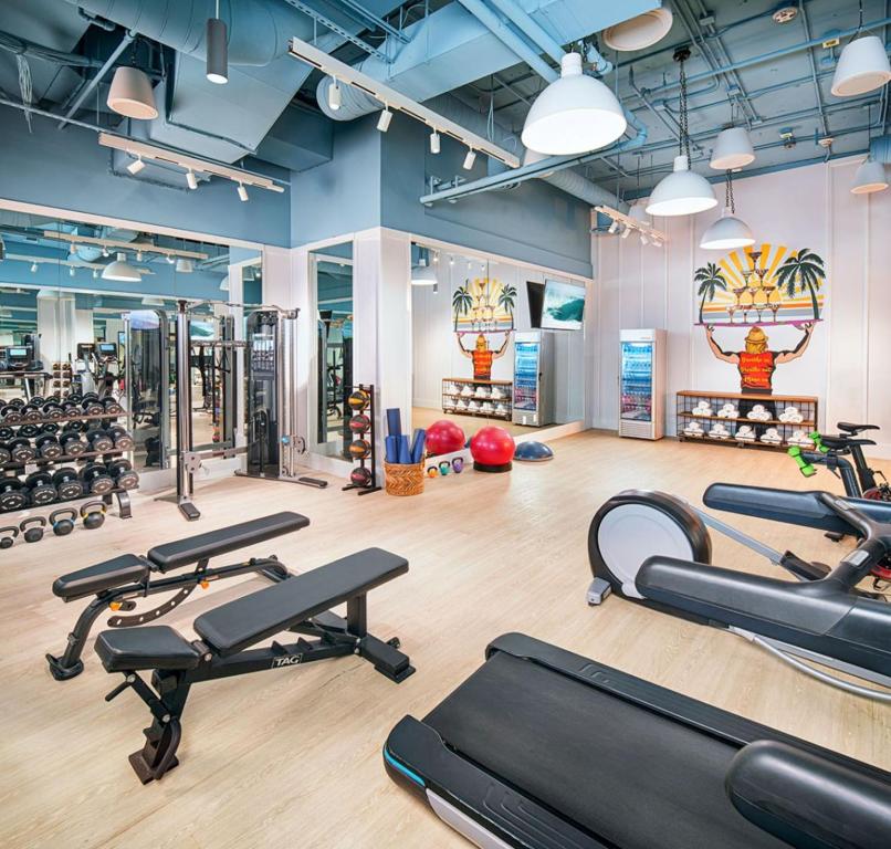 a gym with several treadmills and exercise equipment at Margaritaville Hotel San Diego Gaslamp Quarter in San Diego