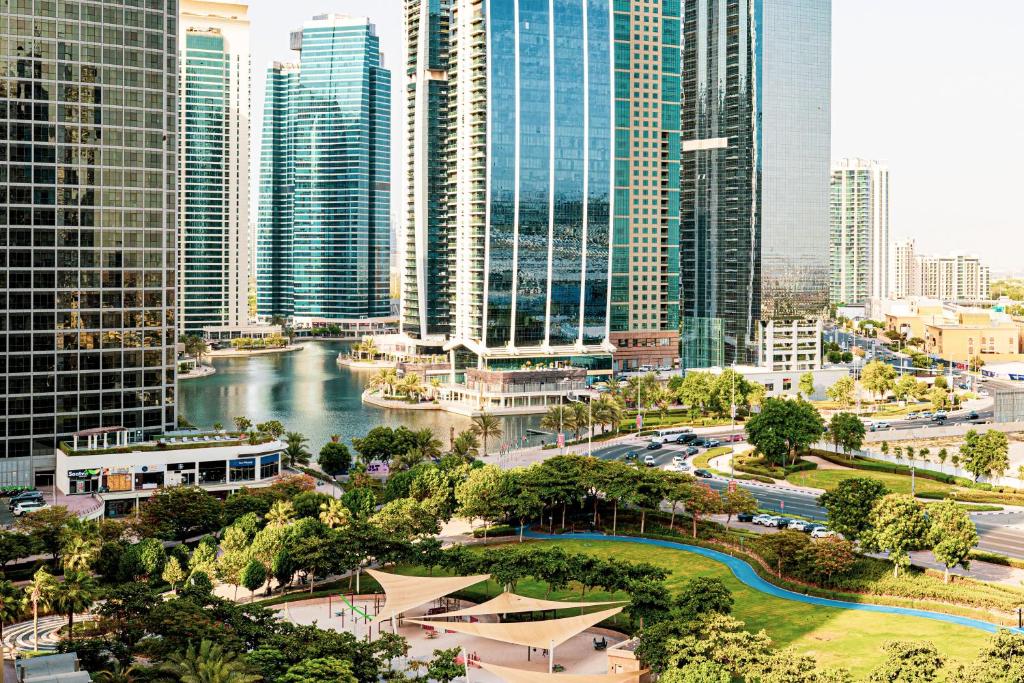 a view of a city with a river and buildings at HomesGetaway - Stylish 1BR Armada Cluster P in Dubai