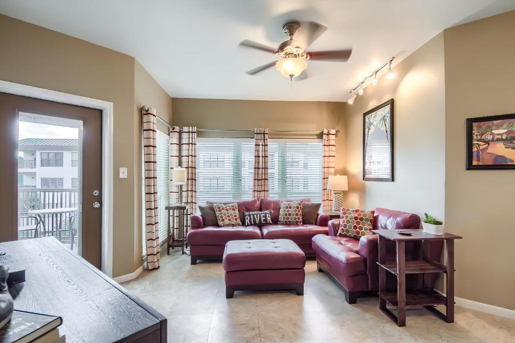 a living room with a couch and a ceiling fan at IC 209 Comal Escape in New Braunfels