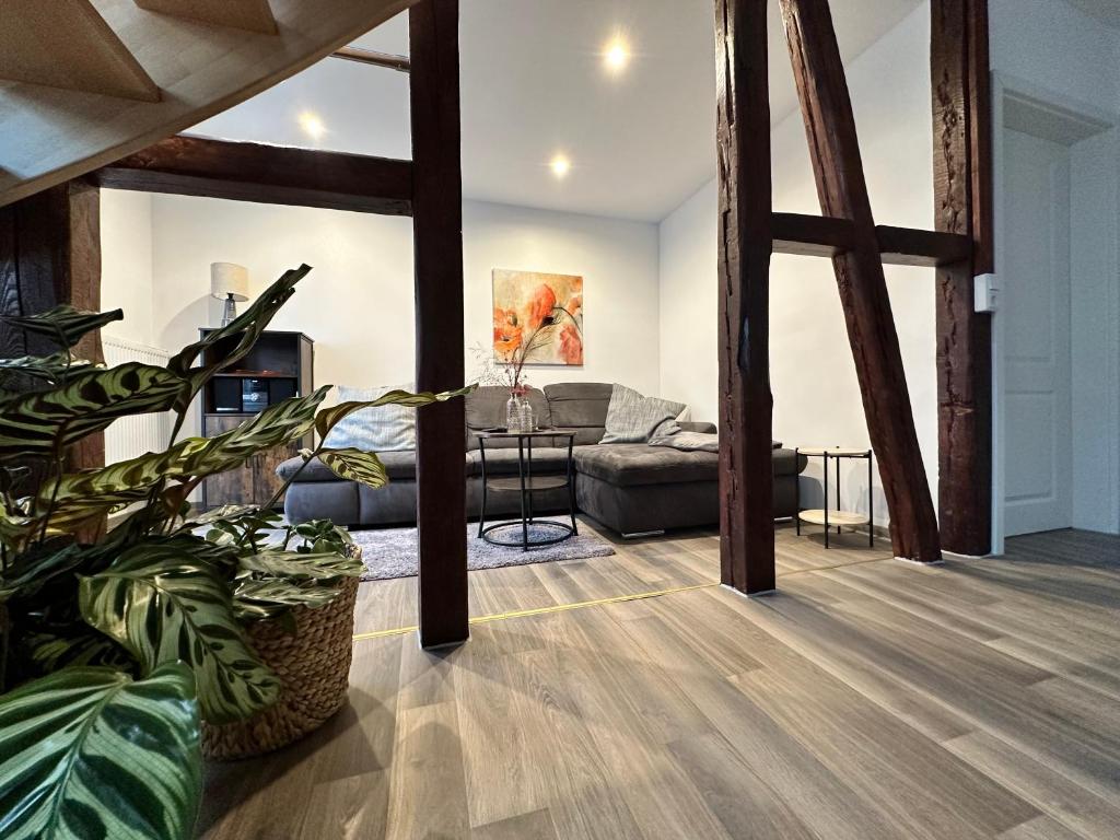 a living room with a couch and a table at Ferienwohnungen Zum Neuhäusel in Quedlinburg