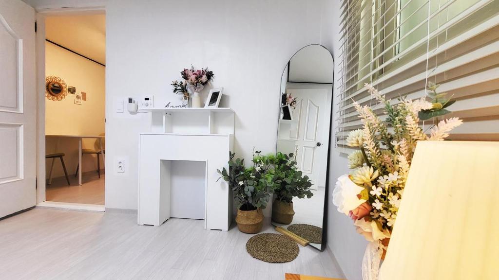 a room with a fireplace and flowers on the wall at Hongdae Stn 2min 2R 1F #Core Stay 101 in Seoul