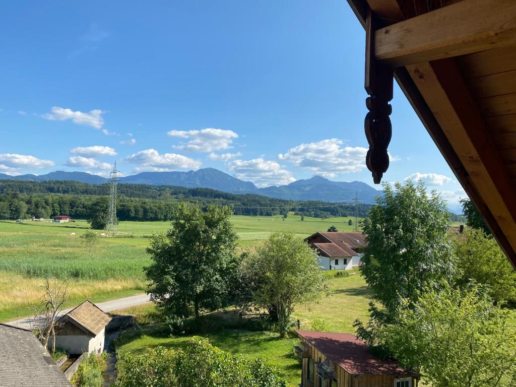 a view of a field and mountains from a house at Taubennest 