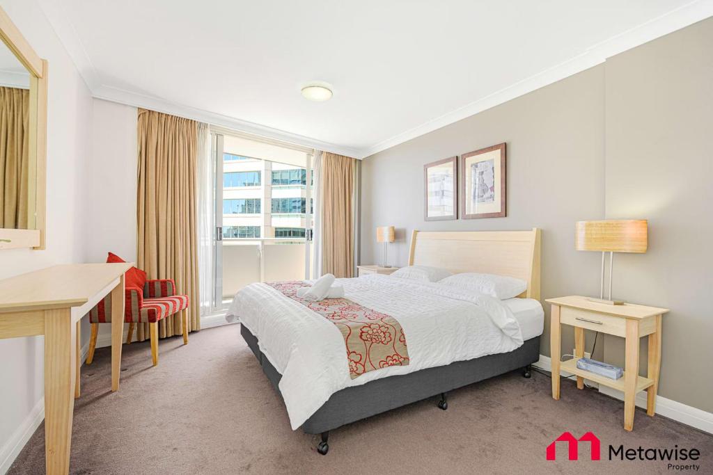 a bedroom with a bed and a desk and a window at MetaWise Chatswood 1Bed next to station in Sydney