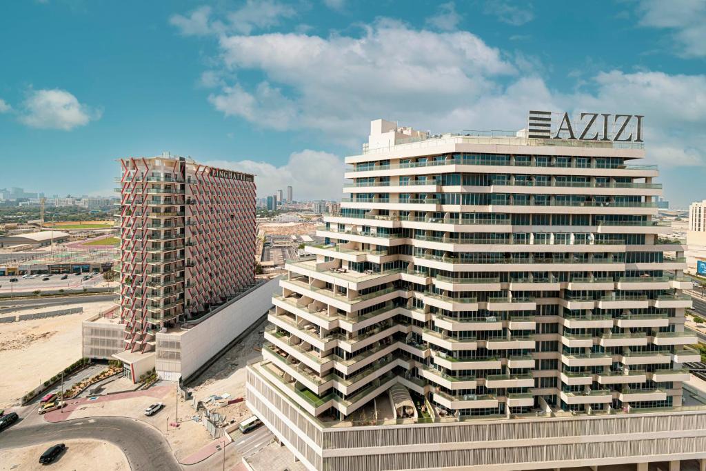 an aerial view of a tall building with aania sign on it at Homesgetaway - Ultraluxury 1BR in Binghatti Creek - Al Jaddaf in Dubai