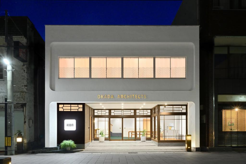 a front view of a building with a store at ROOM design hotel in Nanao