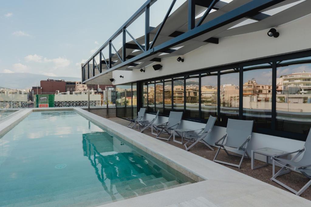 a swimming pool on the roof of a building at Plexi Space in Athens
