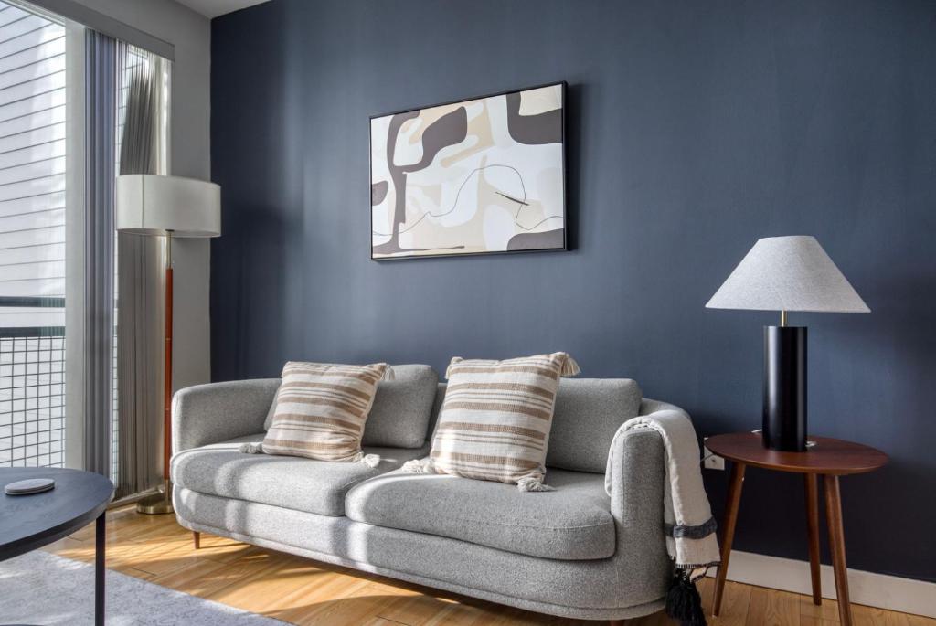 a living room with a couch and a blue wall at South Boston 1br w gym near red line BOS-968 in Boston