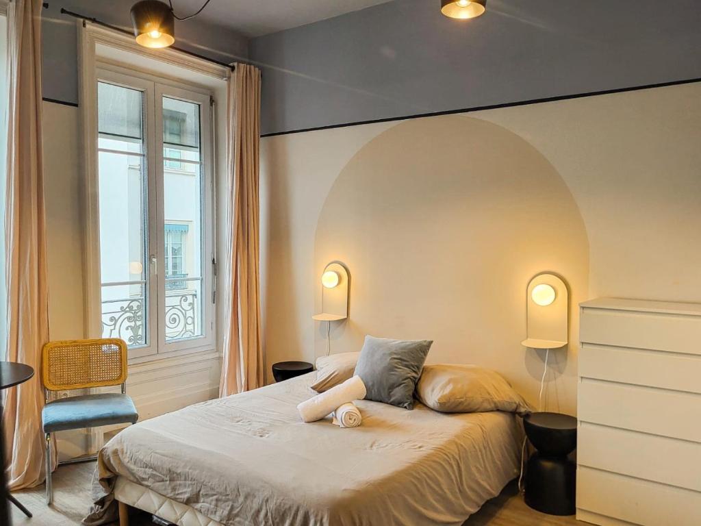 a bedroom with a bed with a stuffed animal on it at Suite Oxymore in Lyon