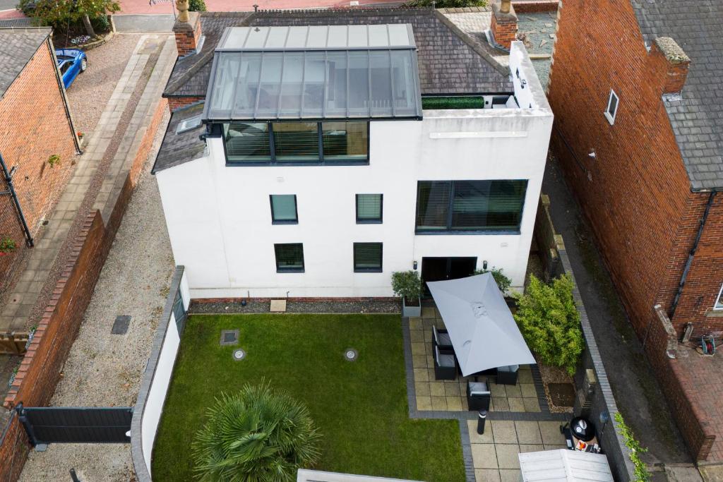 an aerial view of a white house with a yard at Thrushley Cottage in Wakefield - sleeps 7 - with roof terrace 